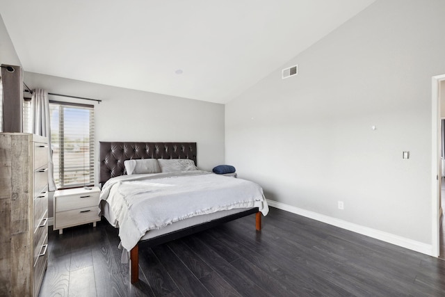 bedroom with dark hardwood / wood-style flooring and vaulted ceiling