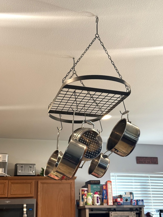 room details with stainless steel microwave and brown cabinets