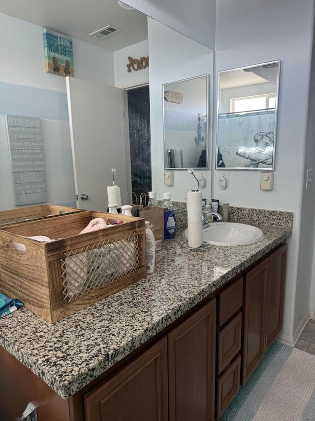 bathroom with visible vents and vanity