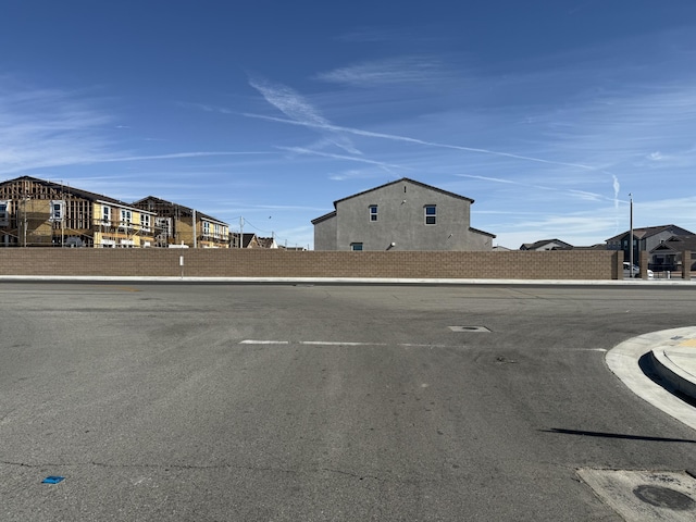 view of street featuring street lights, curbs, and sidewalks