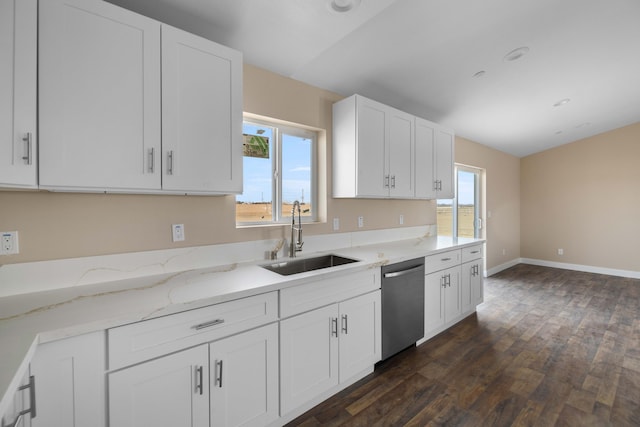 kitchen with dishwasher, light stone countertops, white cabinets, sink, and dark hardwood / wood-style floors