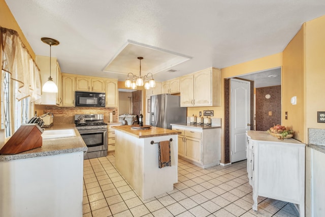 kitchen with a kitchen island, stainless steel appliances, an inviting chandelier, light tile patterned floors, and decorative backsplash