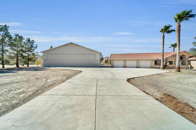8433 Prospect St, Mojave, CA 93501 - view of front of property featuring a tile roof, driveway, and stucco siding