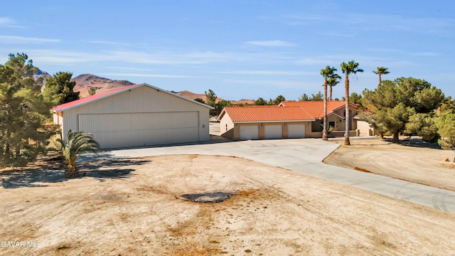 8433 Prospect St, Mojave, CA 93501 - view of front of house featuring driveway and a tile roof