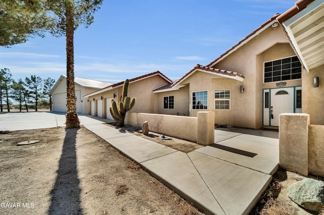 8433 Prospect St, Mojave, CA 93501 - view of front of home featuring stucco siding and a tiled roof