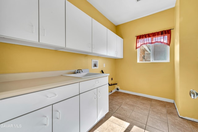8433 Prospect St, Mojave, CA 93501 - laundry area featuring hookup for a washing machine, cabinet space, light tile patterned floors, and electric dryer hookup
