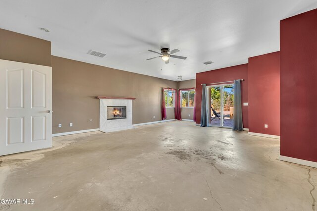 8433 Prospect St, Mojave, CA 93501 - unfurnished living room with unfinished concrete floors, a fireplace, and a ceiling fan
