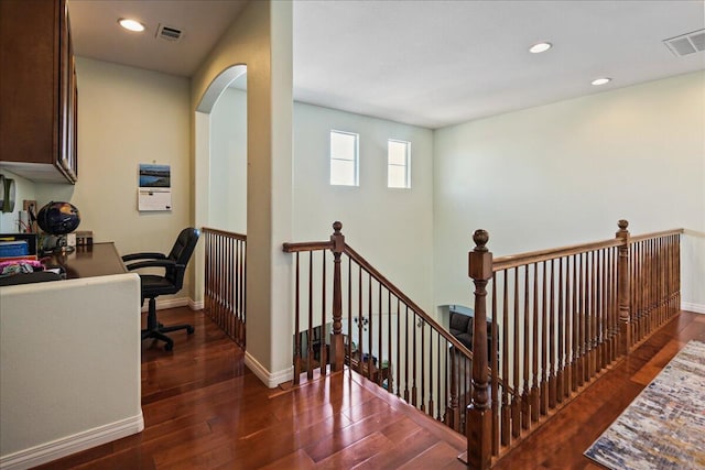 staircase with hardwood / wood-style flooring