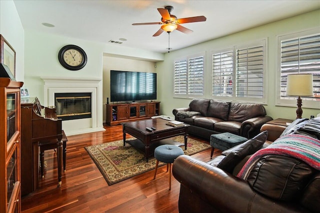 living room with dark hardwood / wood-style floors and ceiling fan