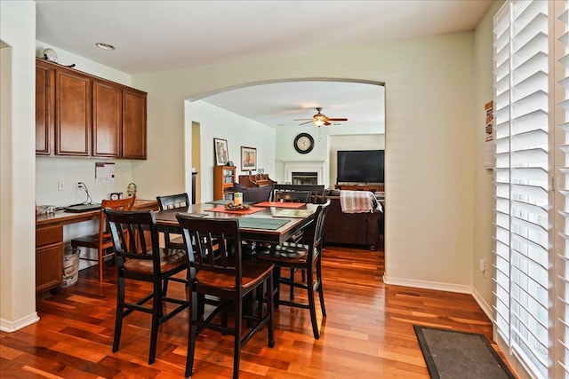 dining space featuring ceiling fan and dark hardwood / wood-style flooring