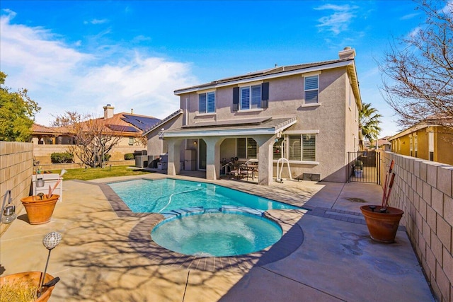 view of swimming pool featuring an in ground hot tub and a patio area