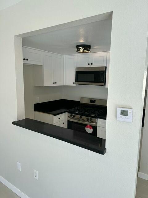 kitchen featuring appliances with stainless steel finishes and white cabinetry