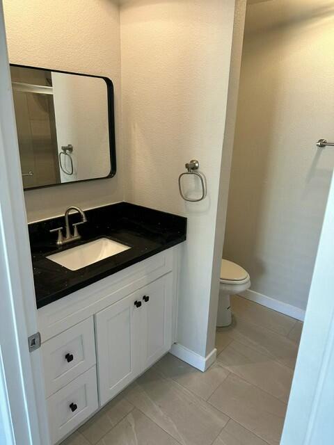 bathroom featuring toilet and vanity