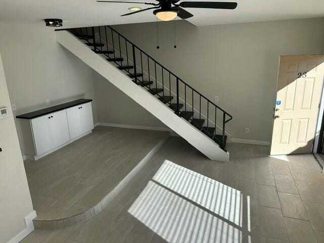 staircase with ceiling fan