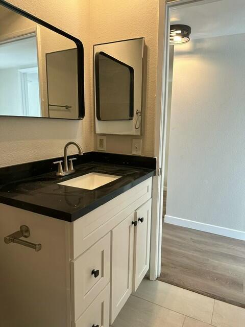 bathroom with tile patterned floors and vanity