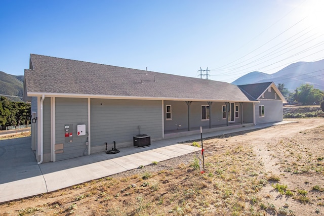 back of property with a patio area and a mountain view