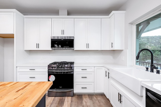 kitchen with white cabinets, appliances with stainless steel finishes, light hardwood / wood-style flooring, and sink