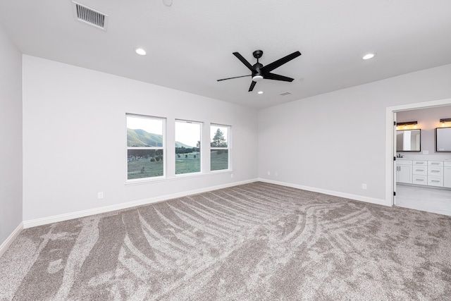 unfurnished room with ceiling fan and carpet flooring