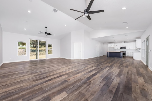 unfurnished living room with sink, high vaulted ceiling, ceiling fan, and dark hardwood / wood-style floors