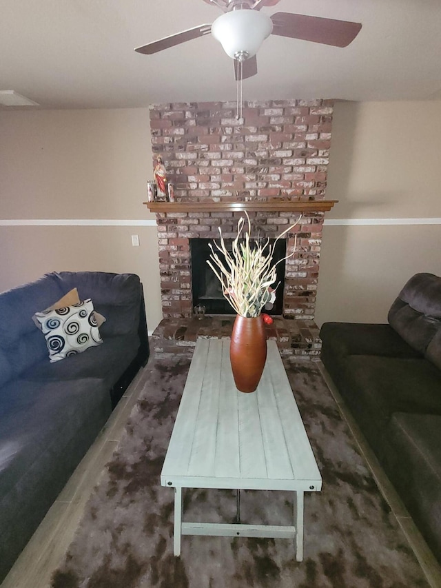 living room featuring a fireplace and ceiling fan