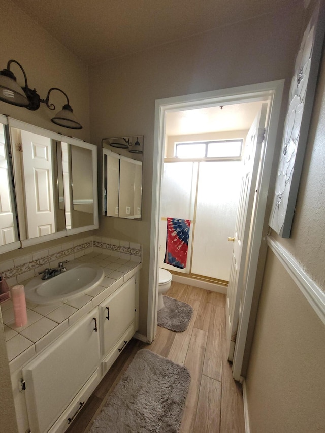 bathroom featuring vanity, hardwood / wood-style floors, and toilet