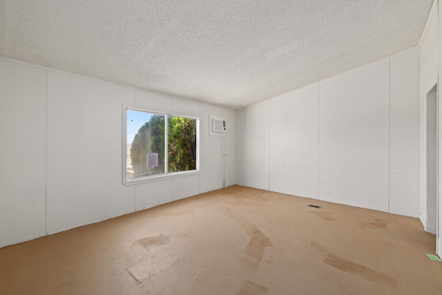 spare room with a textured ceiling