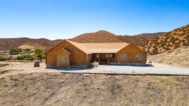 log-style house featuring a mountain view and a porch