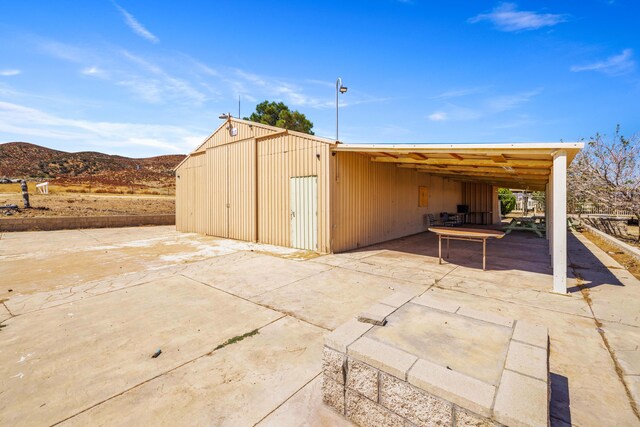 view of outbuilding with a mountain view and a carport