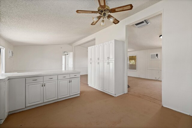 interior space featuring a textured ceiling, ceiling fan, light colored carpet, and lofted ceiling