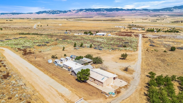 birds eye view of property featuring a mountain view and a rural view