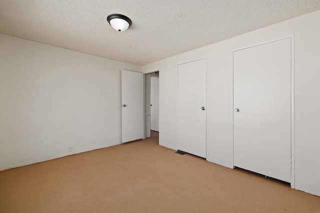 unfurnished bedroom with a textured ceiling