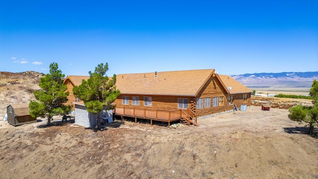 back of property with cooling unit and a deck with mountain view