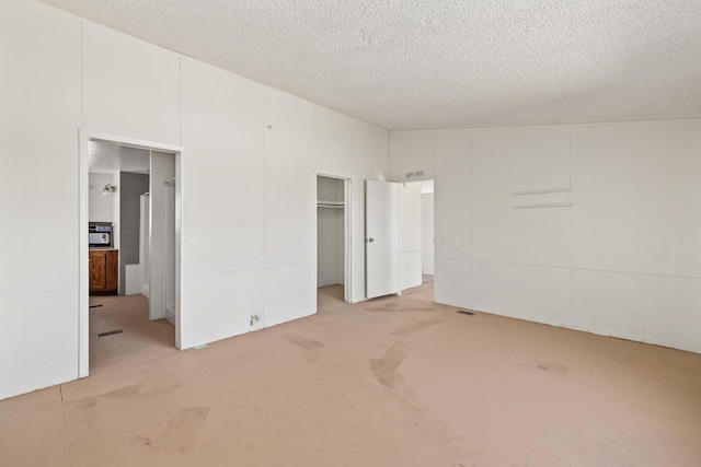 unfurnished bedroom with light carpet and a textured ceiling