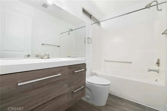 full bathroom featuring vanity, wood-type flooring,  shower combination, and toilet