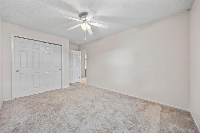 1086 Hickory Ave, Tehachapi, CA 93561 - unfurnished bedroom with a closet, carpet floors, a textured ceiling, and baseboards