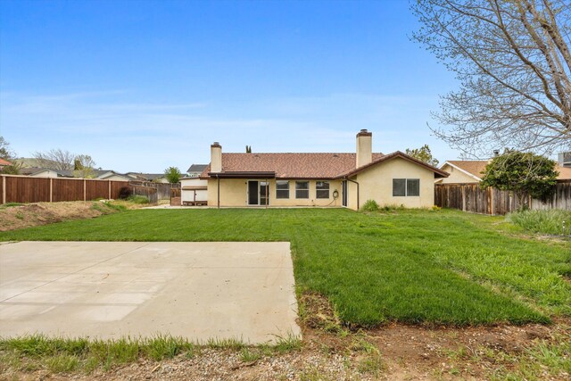 1086 Hickory Ave, Tehachapi, CA 93561 - rear view of house featuring a yard, a patio area, a fenced backyard, and stucco siding