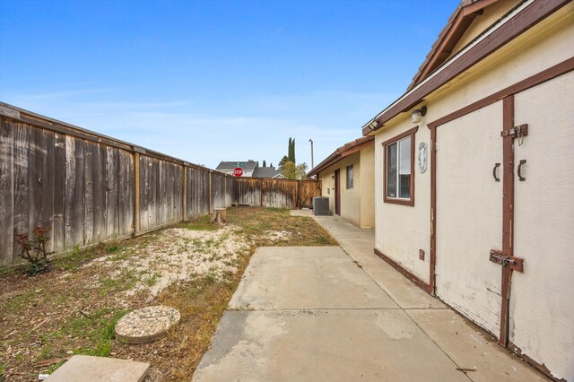 1086 Hickory Ave, Tehachapi, CA 93561 - view of yard featuring a patio area, central AC, and a fenced backyard