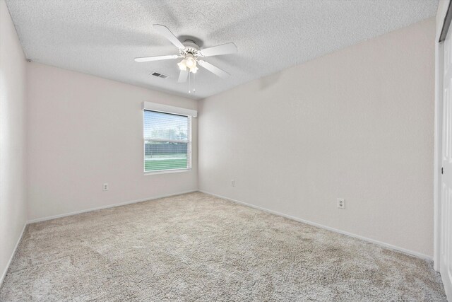 1086 Hickory Ave, Tehachapi, CA 93561 - empty room featuring a textured ceiling, visible vents, carpet flooring, and a ceiling fan