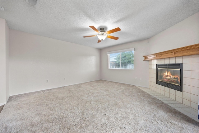 1086 Hickory Ave, Tehachapi, CA 93561 - unfurnished living room featuring a ceiling fan, carpet flooring, a textured ceiling, and a tiled fireplace