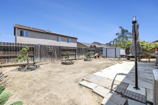 1413 La Quinta Way, Madera, CA 93638 - fenced backyard with a storage shed, a patio, and an outdoor fire pit