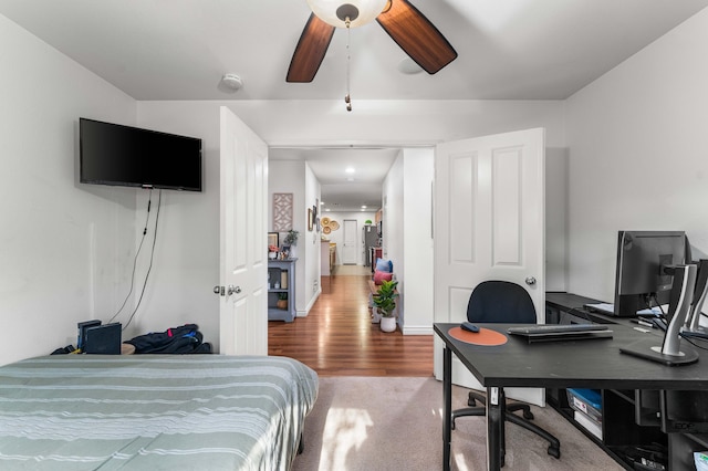 bedroom with ceiling fan and wood-type flooring