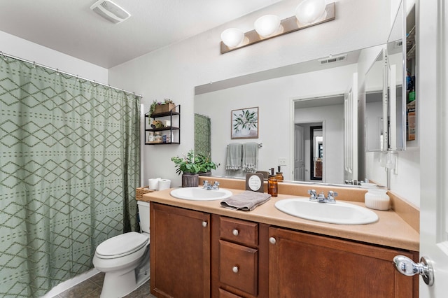 bathroom with tile patterned flooring, vanity, walk in shower, and toilet