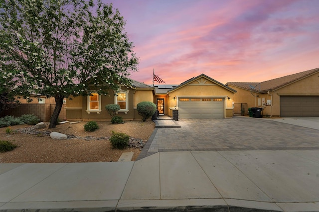 view of front of house with a garage and solar panels