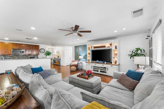 living room featuring hardwood / wood-style flooring and ceiling fan