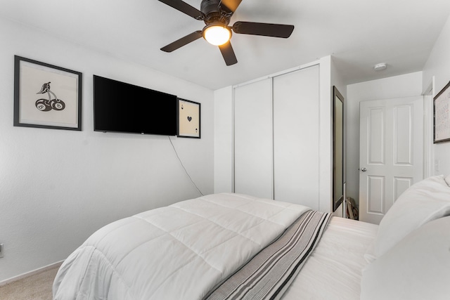 bedroom with carpet floors, a closet, and ceiling fan