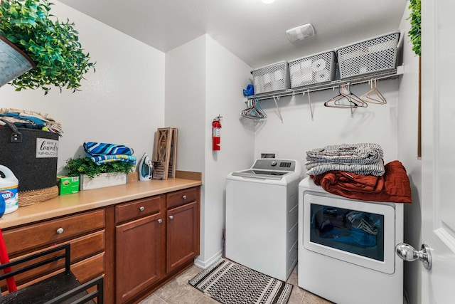 laundry room with light tile patterned flooring and washing machine and dryer