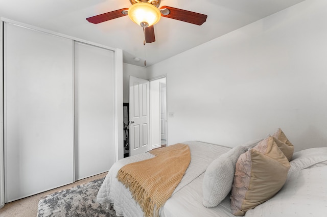 bedroom featuring ceiling fan and a closet