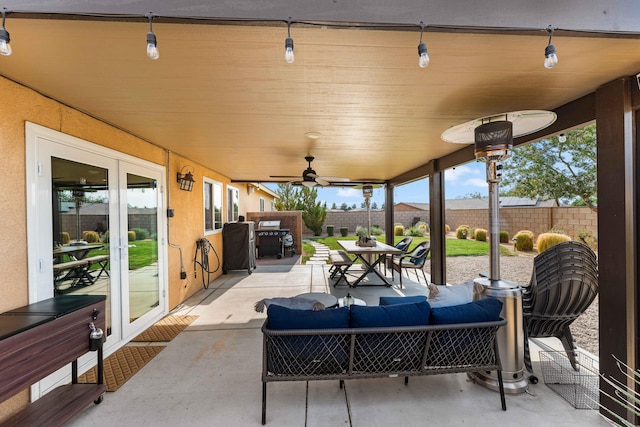 view of patio / terrace featuring an outdoor living space, ceiling fan, and french doors