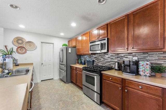 kitchen featuring stainless steel appliances, sink, and decorative backsplash