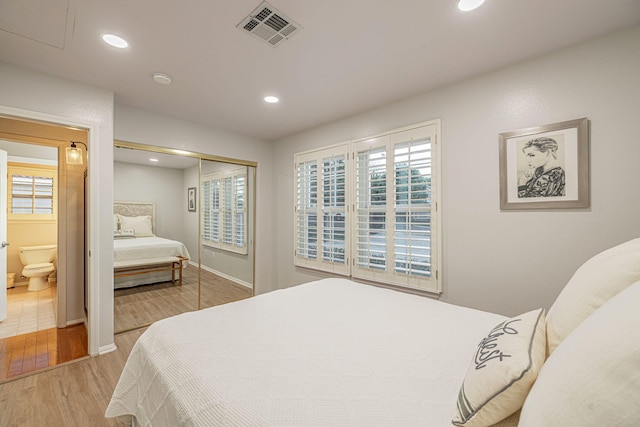 bedroom featuring wood finished floors, recessed lighting, a closet, and baseboards